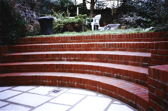 red brick curved steps in small brighton garden